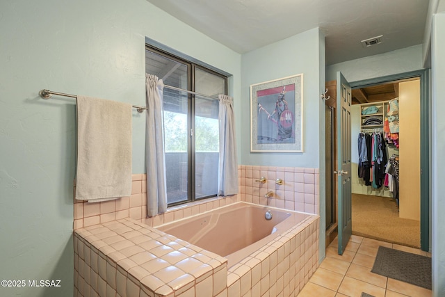 bathroom featuring tile patterned flooring and shower with separate bathtub