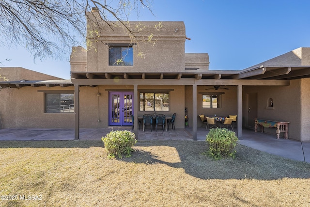 rear view of house featuring ceiling fan, french doors, and a patio area