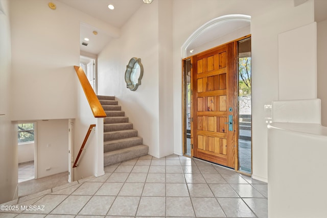 tiled entryway featuring vaulted ceiling