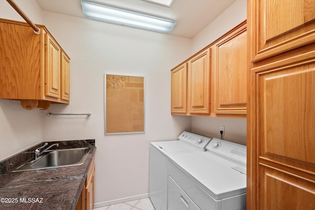 laundry area with cabinets, sink, independent washer and dryer, and light tile patterned flooring