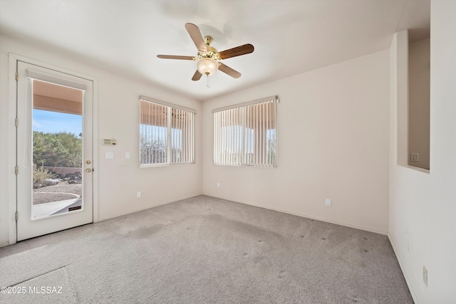 empty room featuring ceiling fan and light colored carpet