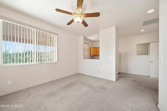 spare room featuring ceiling fan and light colored carpet