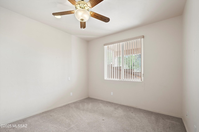 unfurnished room with ceiling fan and light colored carpet