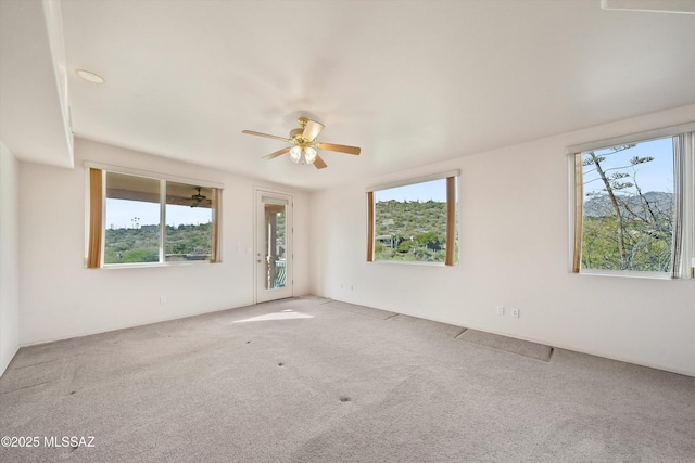 empty room featuring carpet floors, plenty of natural light, and ceiling fan