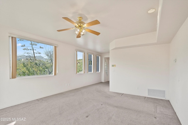 unfurnished room with light carpet, ceiling fan, and plenty of natural light