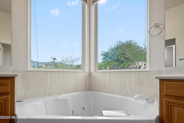 bathroom with vanity and a bath