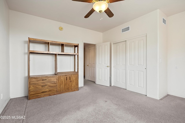 unfurnished bedroom featuring ceiling fan and light colored carpet