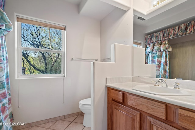 bathroom featuring tile patterned floors, vanity, and toilet