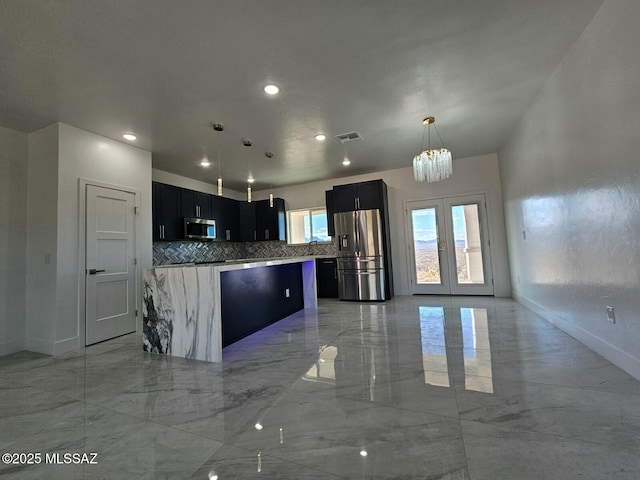 kitchen featuring dark cabinets, visible vents, a kitchen island, marble finish floor, and stainless steel appliances