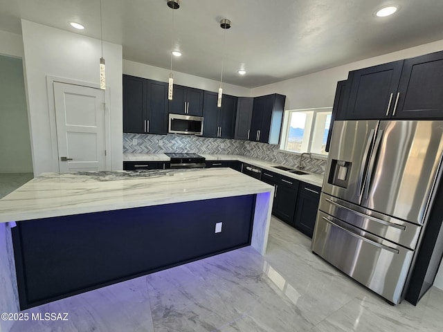 kitchen with a center island, appliances with stainless steel finishes, marble finish floor, a sink, and light stone counters