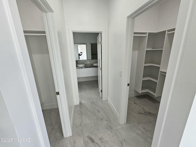 walk in closet with marble finish floor