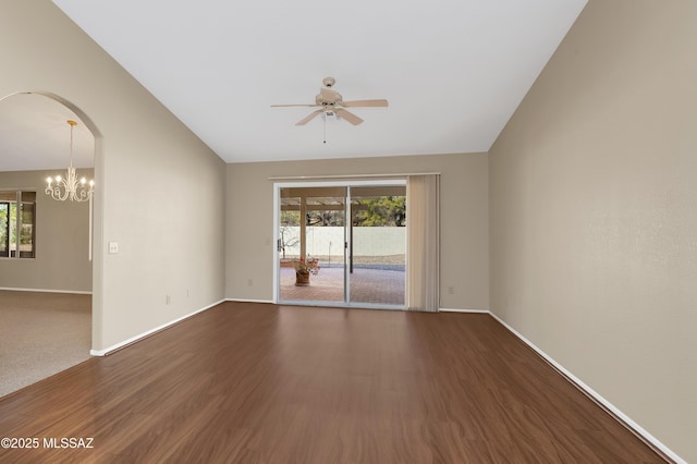 unfurnished room featuring dark wood-type flooring, lofted ceiling, and ceiling fan with notable chandelier