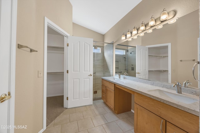 bathroom featuring tile patterned floors, vanity, an enclosed shower, and vaulted ceiling