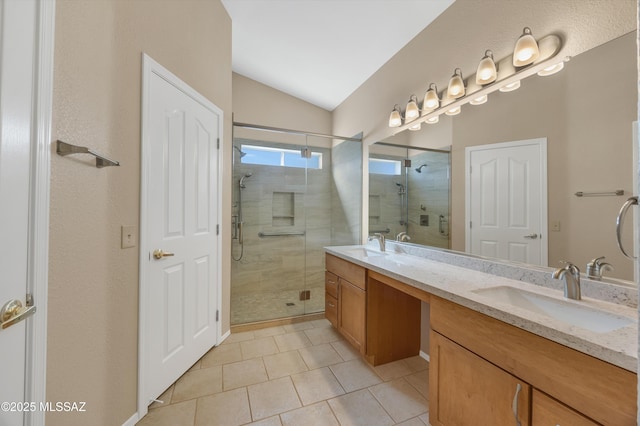 bathroom featuring walk in shower, vanity, tile patterned flooring, and lofted ceiling