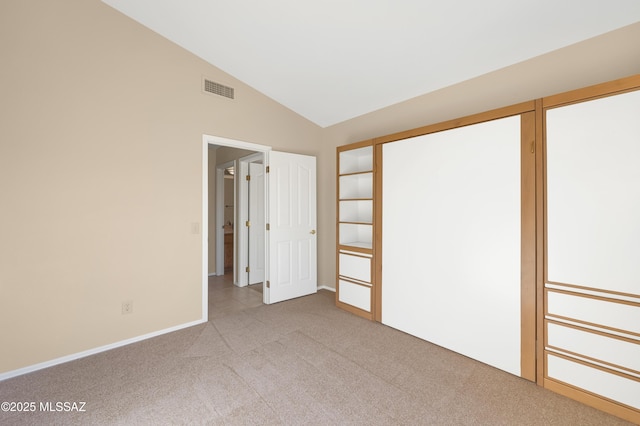 unfurnished room with light carpet and vaulted ceiling