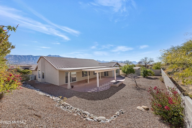 back of property featuring a patio area and a mountain view