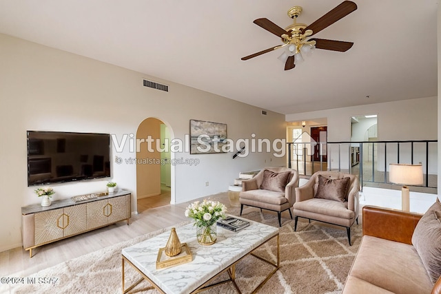 living room with ceiling fan and hardwood / wood-style floors