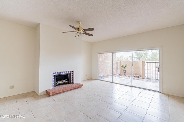 unfurnished living room with ceiling fan, light tile patterned floors, and a textured ceiling