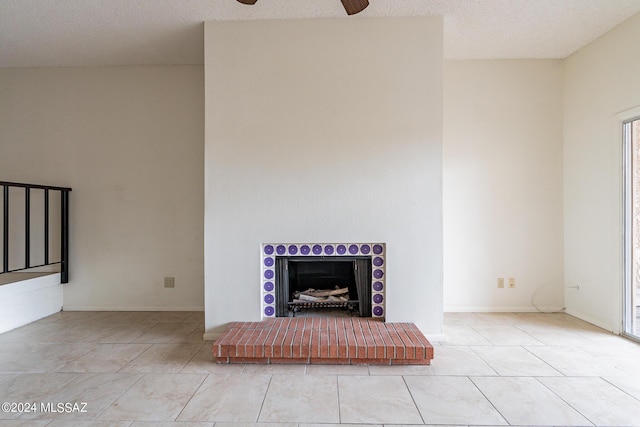 unfurnished living room featuring light tile patterned floors, a textured ceiling, and ceiling fan