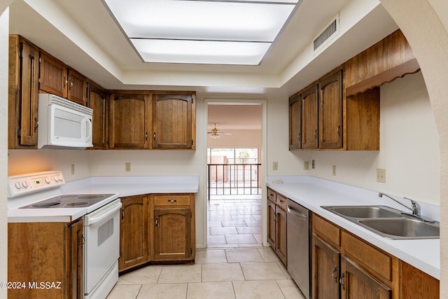 kitchen with ceiling fan, light tile patterned flooring, white appliances, and sink