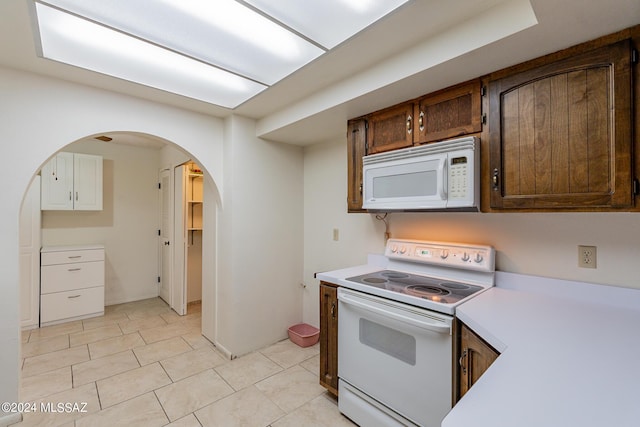 kitchen with light tile patterned floors and white appliances