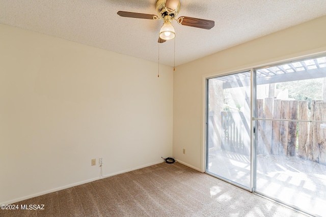 empty room with carpet, ceiling fan, and a textured ceiling