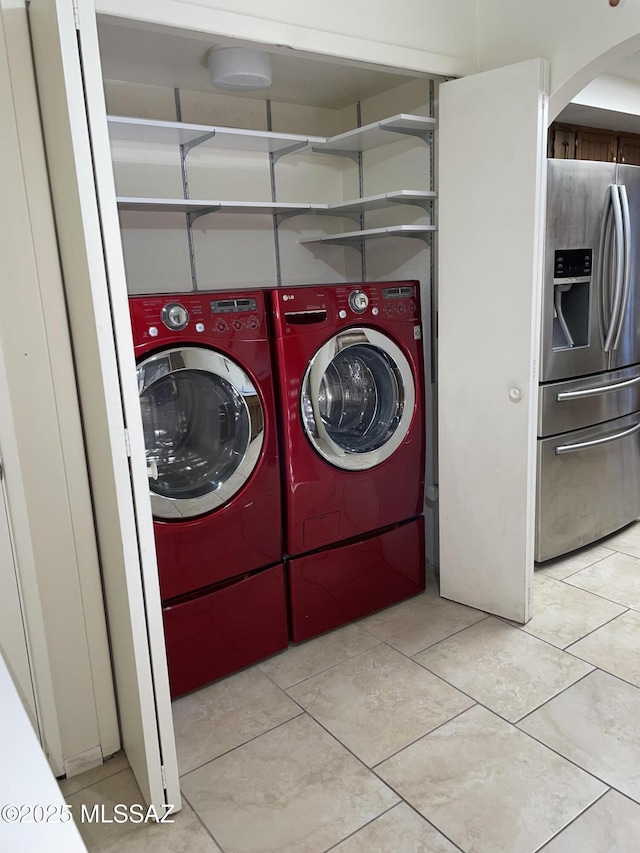 washroom with separate washer and dryer and light tile patterned flooring