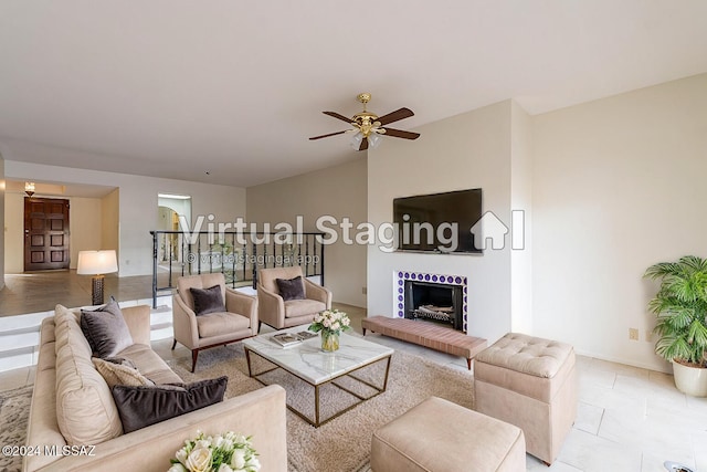 living room with ceiling fan, a fireplace, and light tile patterned flooring