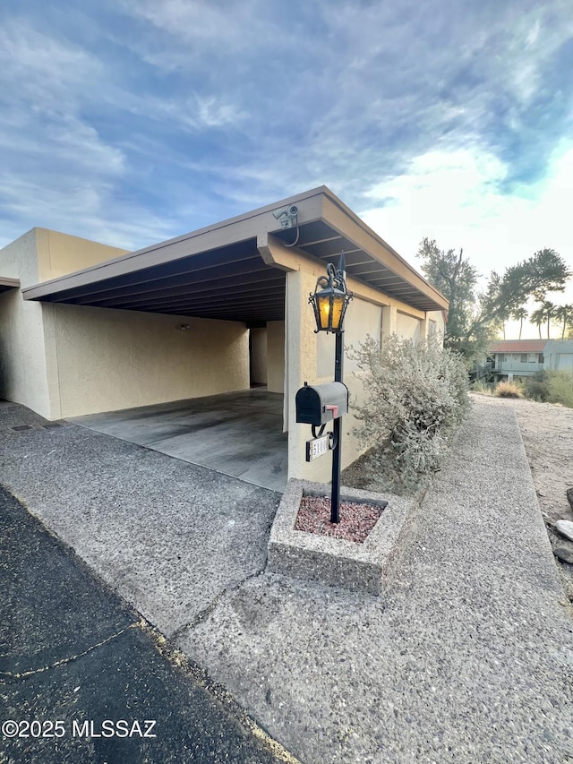 view of side of home with a carport