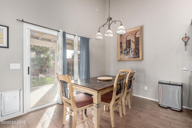 dining space with an inviting chandelier and hardwood / wood-style flooring