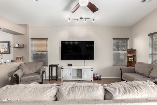 living room with dark hardwood / wood-style flooring and ceiling fan