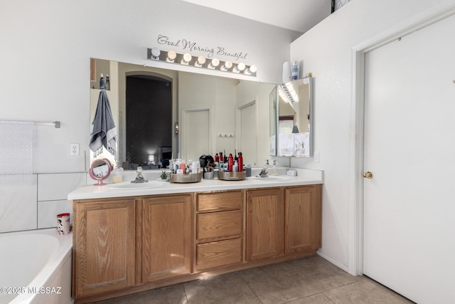 bathroom with vanity, tile patterned floors, and a bathing tub