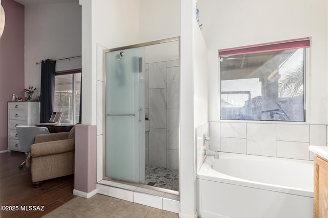 bathroom with vanity, plus walk in shower, and hardwood / wood-style floors