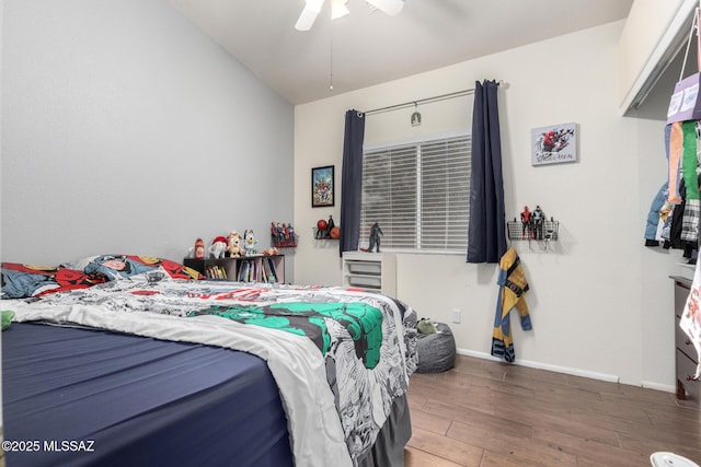 bedroom featuring vaulted ceiling, dark hardwood / wood-style floors, and ceiling fan