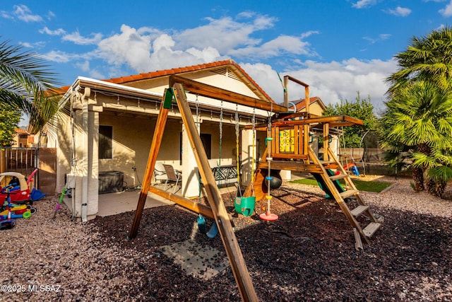 view of jungle gym with a patio area and a trampoline