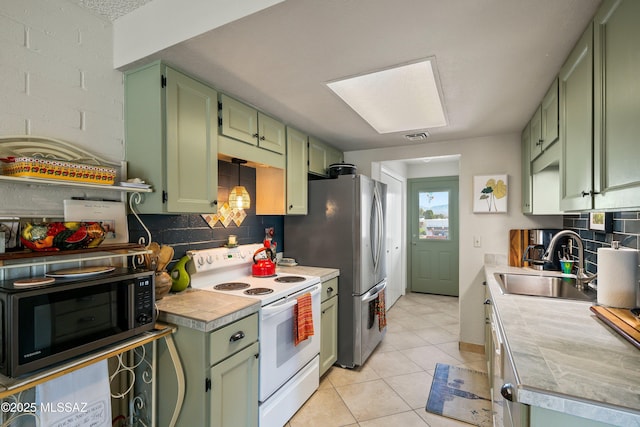 kitchen featuring tasteful backsplash, white electric range, green cabinetry, and a sink