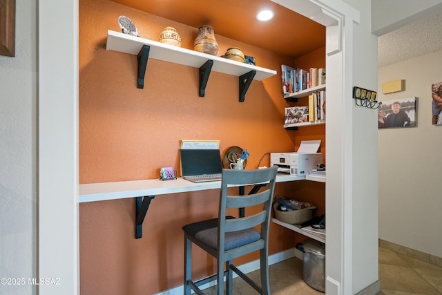 home office featuring built in desk, recessed lighting, a textured ceiling, tile patterned flooring, and baseboards