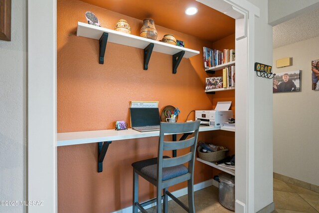 home office featuring built in desk and tile patterned floors