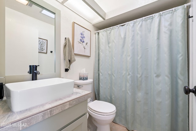 full bathroom featuring vanity and toilet