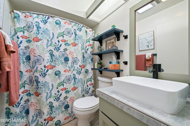 bathroom with vanity, toilet, and curtained shower