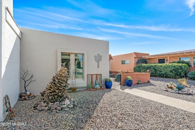 exterior space featuring french doors and stucco siding