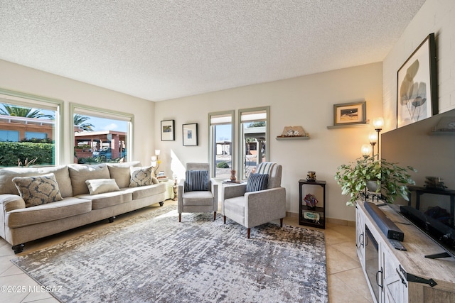 living room featuring light tile patterned floors, a textured ceiling, and plenty of natural light