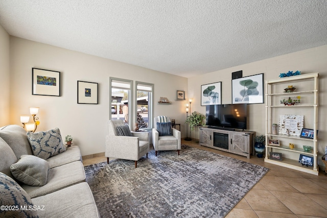 tiled living room featuring a textured ceiling