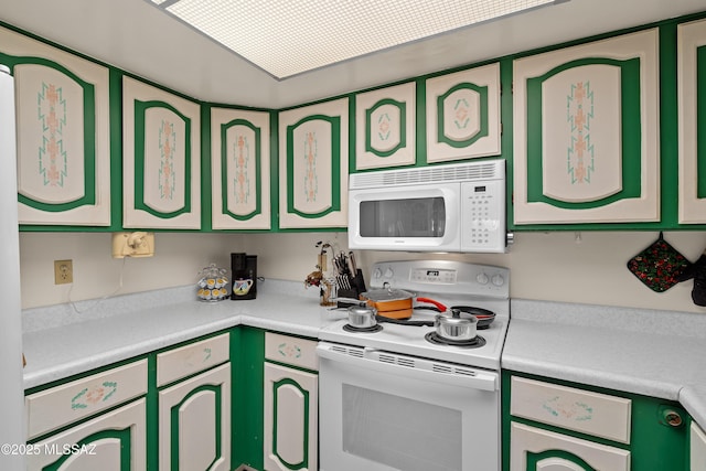 kitchen with white appliances and green cabinets