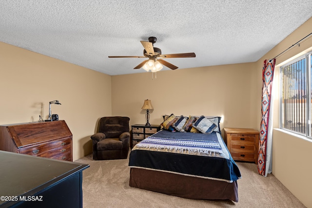 bedroom with multiple windows, ceiling fan, light carpet, and a textured ceiling