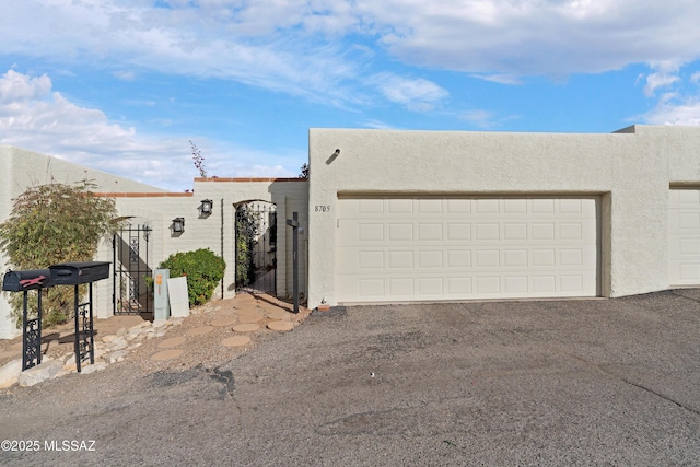 pueblo-style house featuring a garage