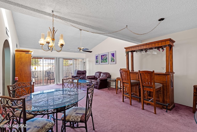 carpeted dining room with ceiling fan with notable chandelier, a textured ceiling, and vaulted ceiling