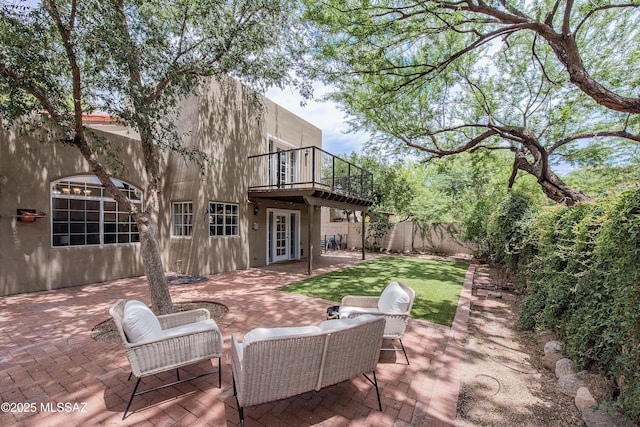 view of patio with a balcony and an outdoor living space