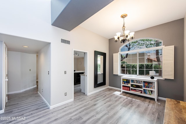 interior space with an inviting chandelier and wood-type flooring