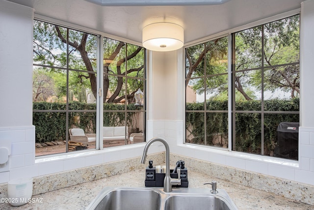 kitchen with sink and light stone counters